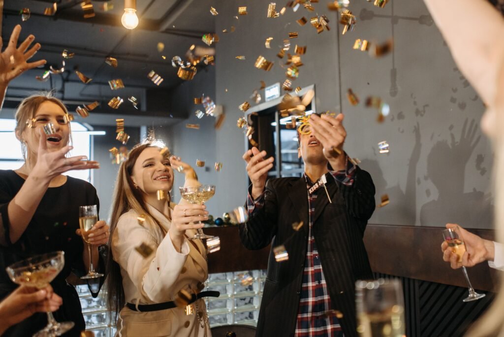 Employees celebrating at a corporate event with permanent jewelry